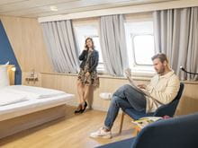 Couple relaxing in a spacious luxurious 2 berth cabin